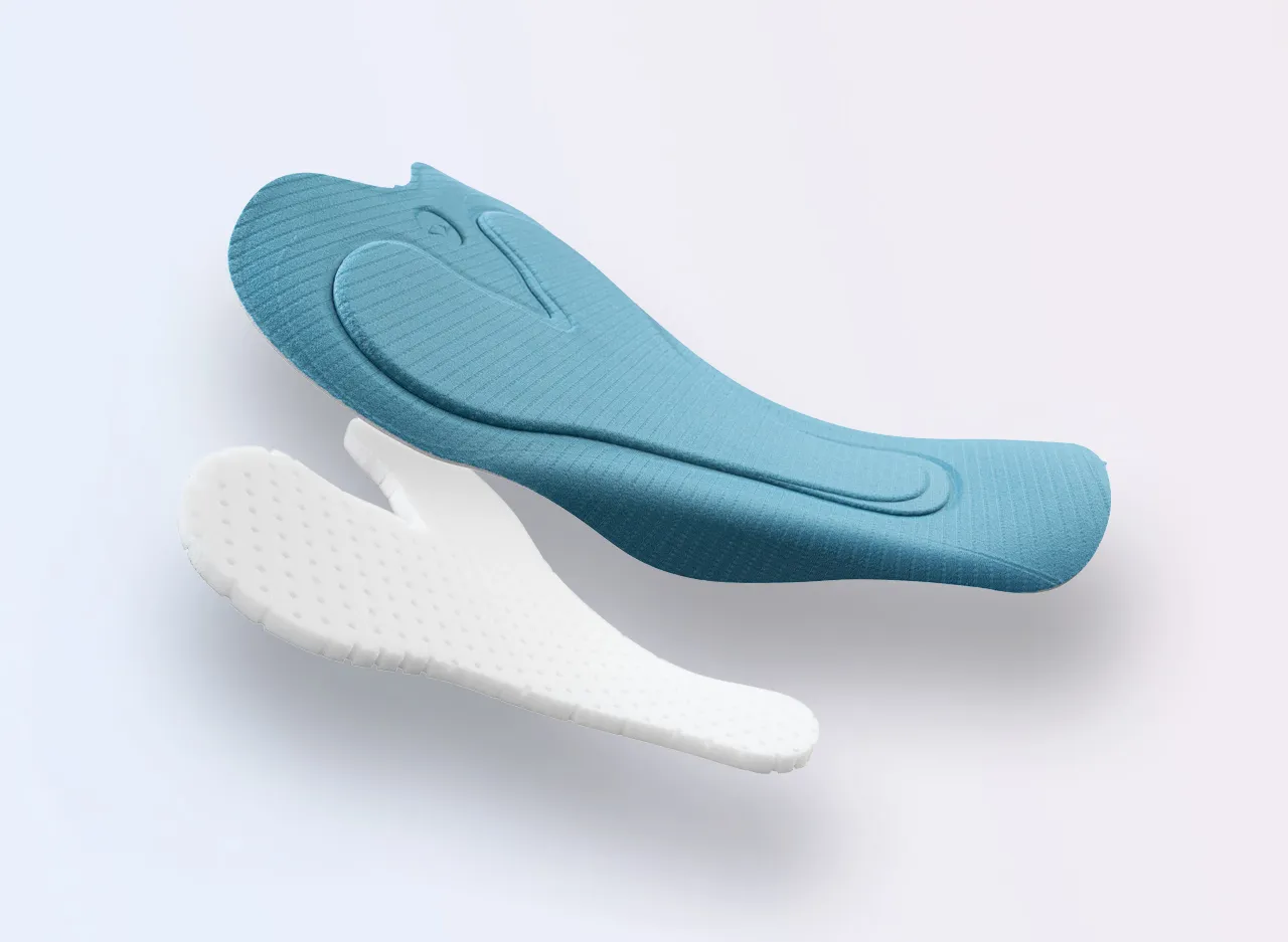Two foot pads in blue and white, featuring a non-slip surface and ergonomic shape.